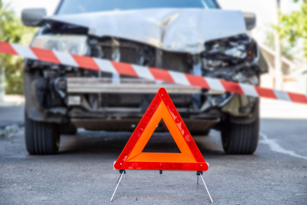 Harvard sign and tape in front of a crashed car
